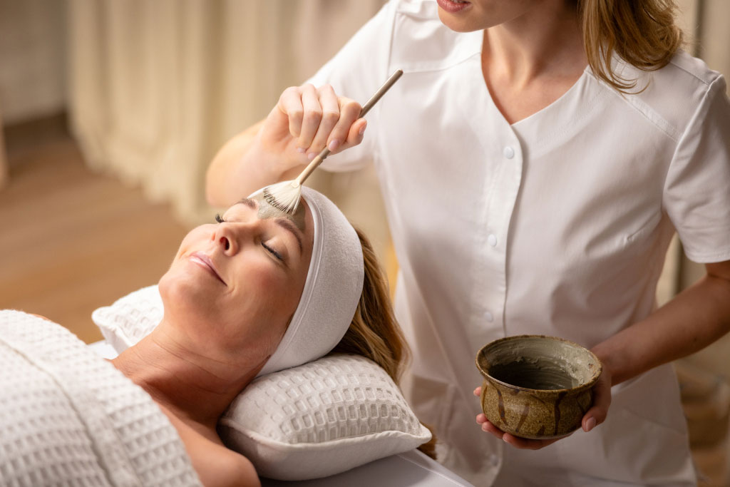Woman receiving face mask treatment