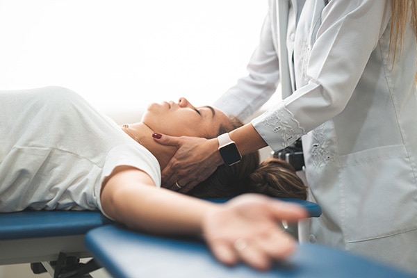 Chiropractor adjusting patient's neck