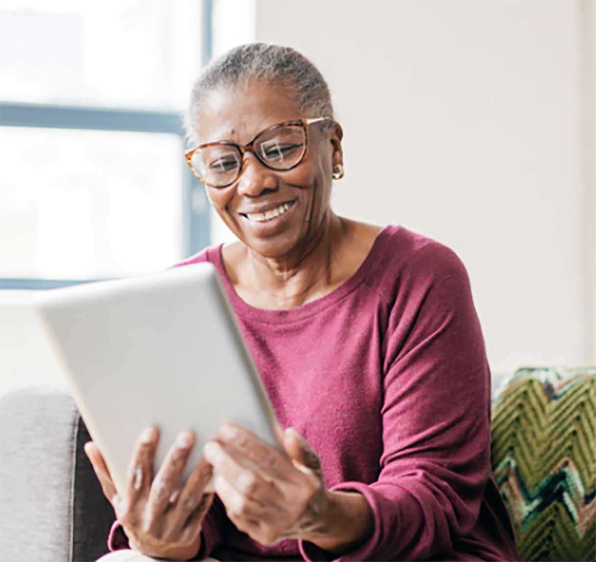 Senior woman, looking at a tablet