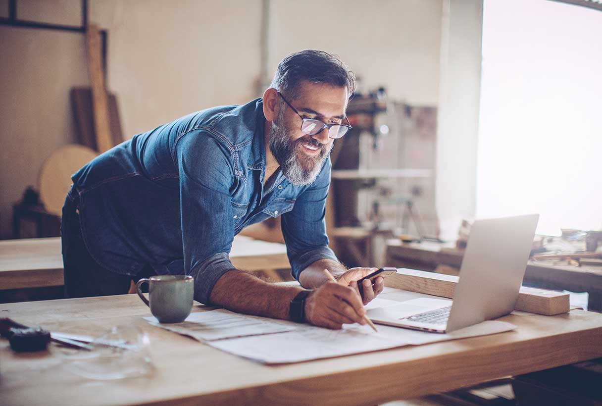 Smiling man looking at laptop