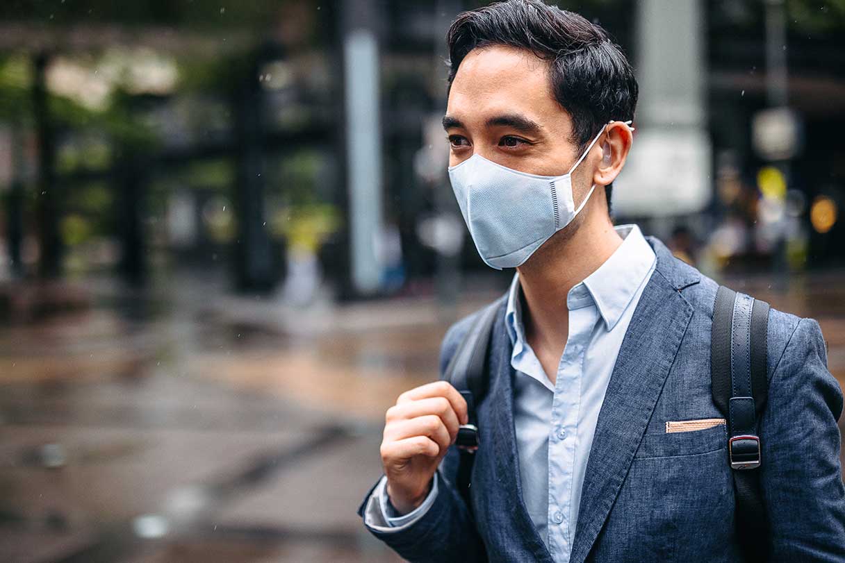 Man wearing disposable blue mask