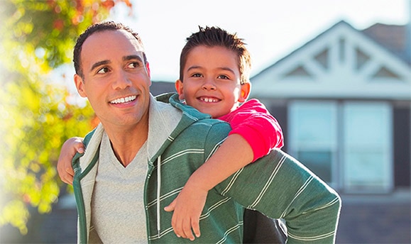 Man holding child on his back