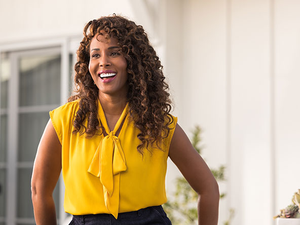 Woman in yellow shirt smiling