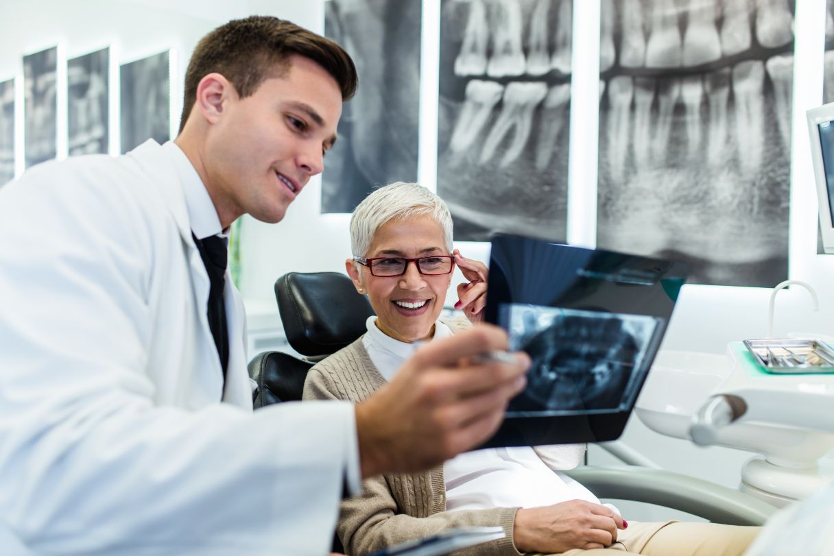 Dentist showing patient an x-ray image