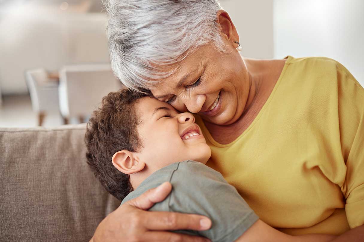 Senior woman hugging young boy