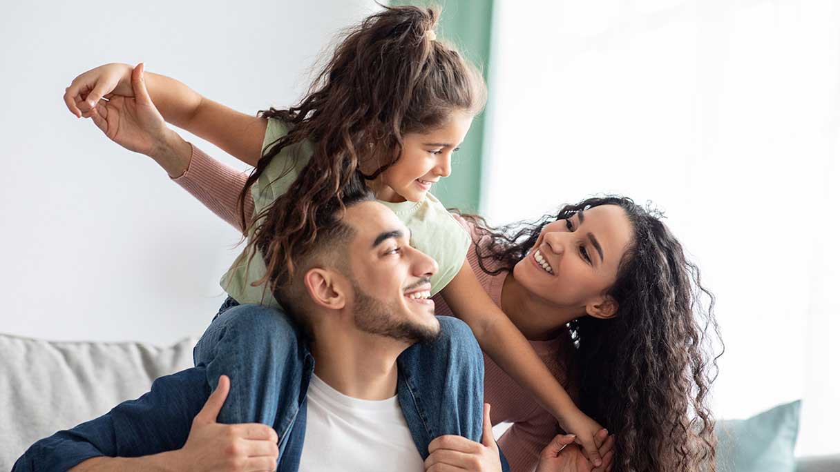 Family sitting together on couch