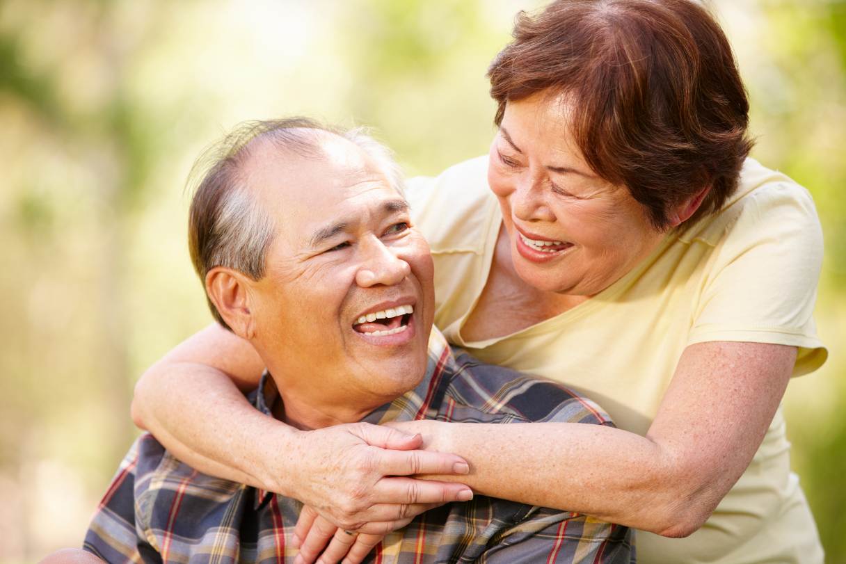 Senior couple, smiling at each other