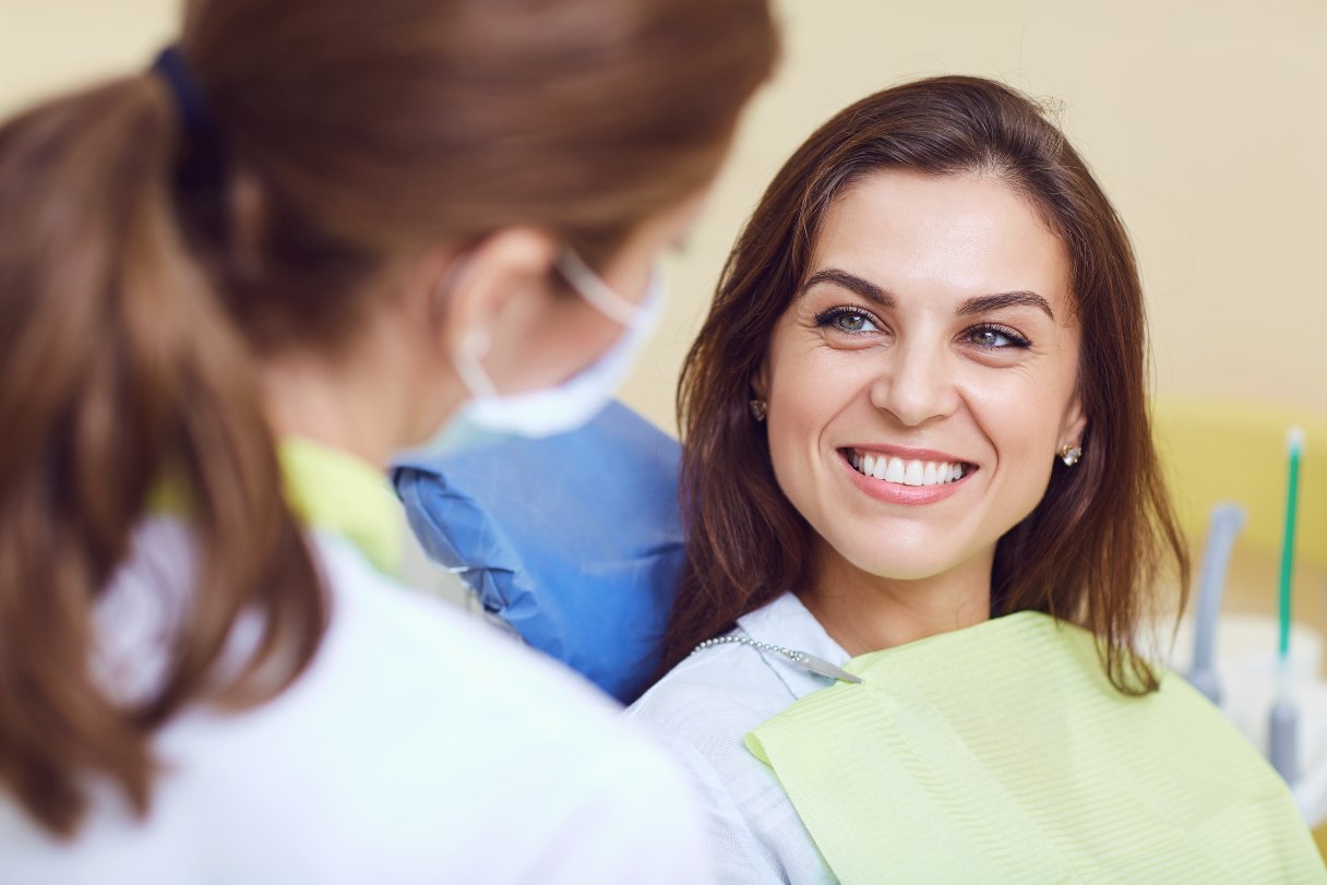 Woman smiling up at a dentist