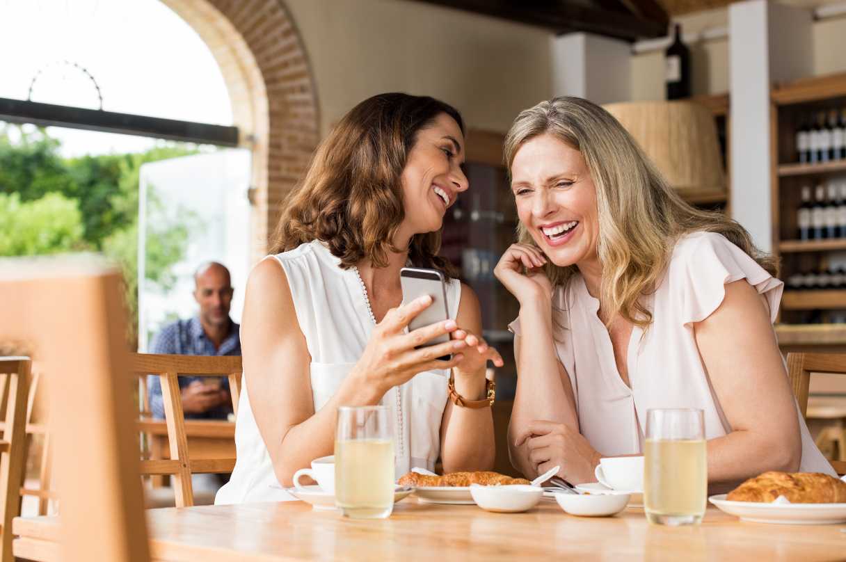 Two women in restaurant, laughing together