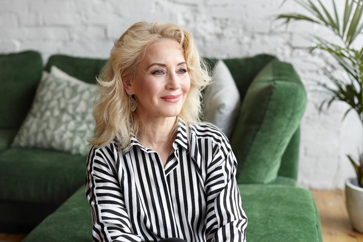 Smiling woman sitting on sofa