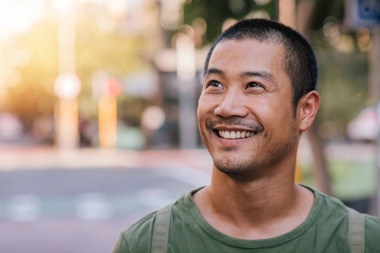 Close-up of man in green shirt smiling