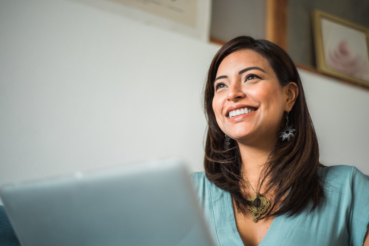 Smiling woman working on laptop