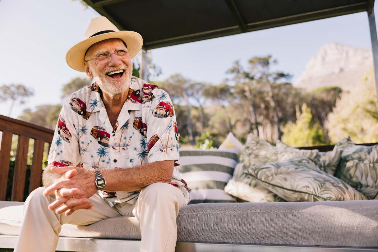 Smiling man sitting outside