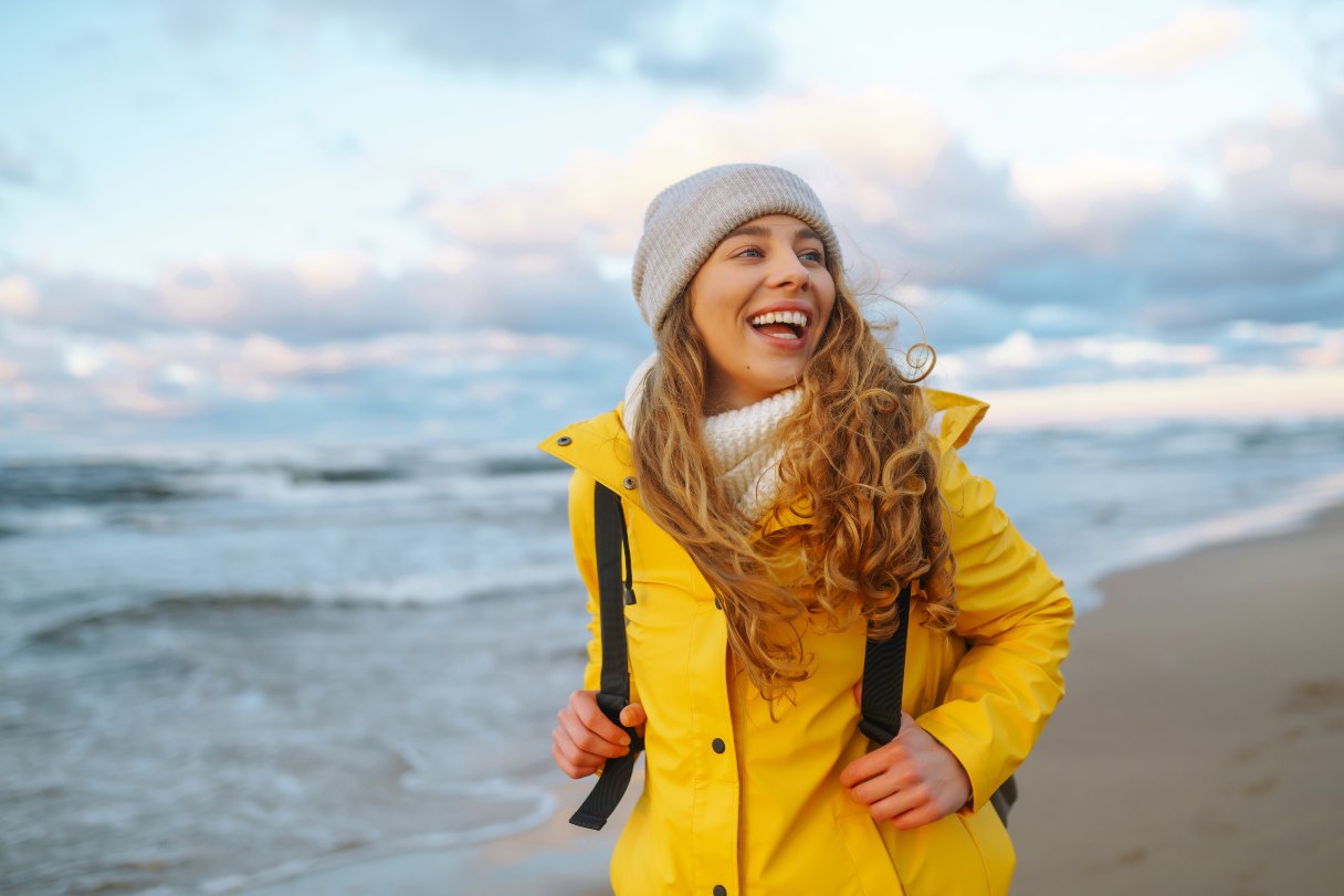 Smiling woman walking on a beach