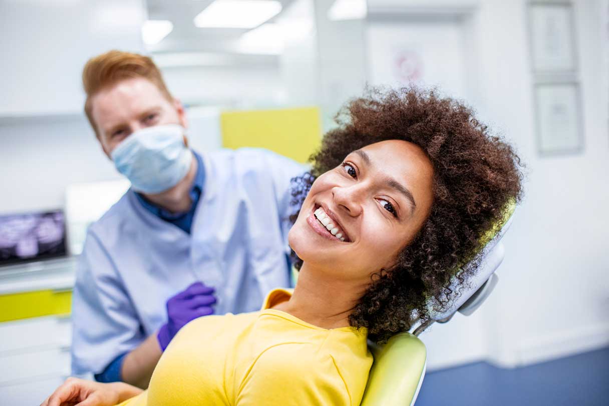 Woman in dental examination chair, smiling