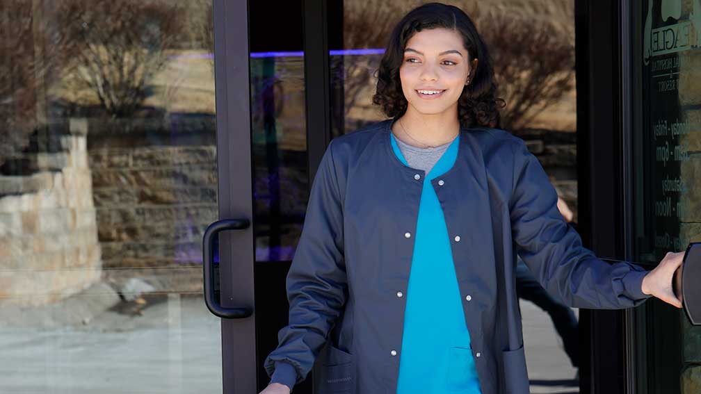 Veterinary technician walking out of practice