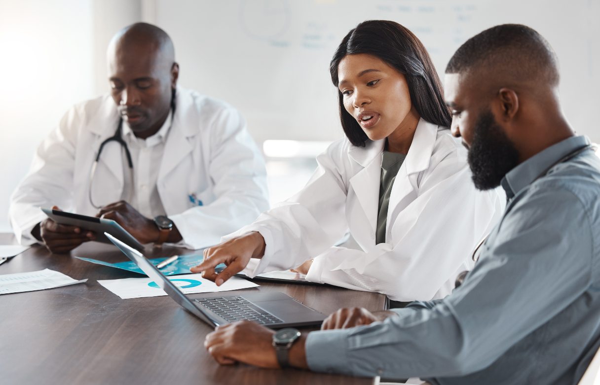 Three health professionals working together at conference table